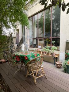 a table and chairs on a deck with flowers on it at Warm and cosy Loft in paris with a private outdoor in Paris +11 photos