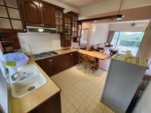 a kitchen with a sink and a counter top at Little England B8-3 in Bukit Fraser