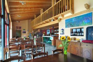 a dining room with a long table and chairs at Eco Hotel Locanda del Giglio in Roveredo Capriasca