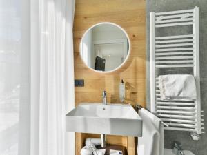 a bathroom with a white sink and a mirror at Hotel Zerbion in Torgnon