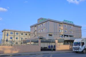 a white truck parked in front of a building at Sharaf Hotel Dire Dawa in Dirē Dawa