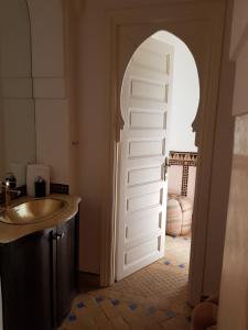 a door leading into a bathroom with a sink at Private Villa at Jardins de Touhina in Marrakesh +17 photos