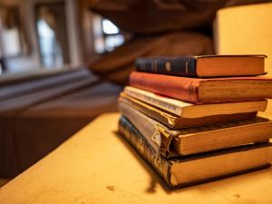 a stack of books sitting on a table at Firefly boutique Hotel Zanzibar in Zanzibar City