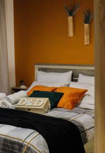 a bed with a book on top of it at D&D rooms Nafplio in Nafplio +34 photos