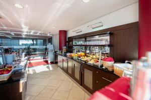 a restaurant with a buffet line with food at Aspire AcarA Oldenburg, Trademark Collection by Wyndham in Oldenburg