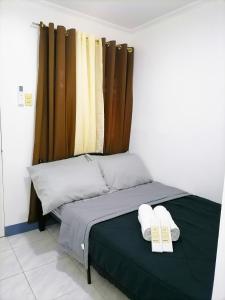 a bedroom with a bed with two towels on it at Mr B Guest House Room Rentals in San Fernando, Cebu in San Fernando