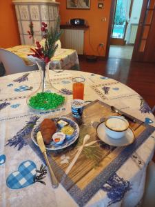 a table with a plate of food and a cup of coffee at B&B Signora Minù in Perugia