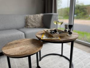 a couple of tables in a living room with wine glasses at Huisje in Dishoek in Koudekerke +16 photos