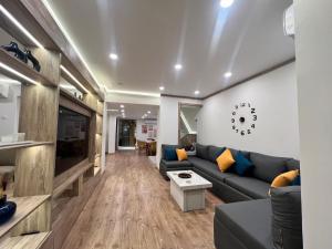 a living room with a couch and a tv at Duplex 3Bedroom Apartment Overlooking Giza Zoo Perfect for Families and Friends in Cairo +44 photos