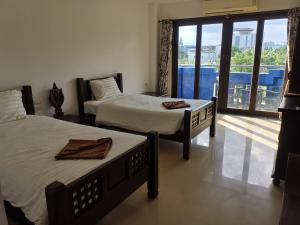 Postel nebo postele na pokoji v ubytování บ้านอันดามัน กระบี่