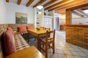 a kitchen and dining room with a table and a couch at Villa Can Mestre con vistas a la puesta de Sol in San Antonio Bay