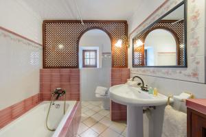 a bathroom with a tub and a sink and a bath tub at Villa Can Mestre con vistas a la puesta de Sol in San Antonio Bay +37 photos