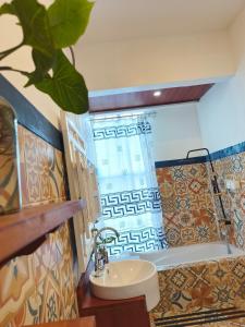 a bathroom with a sink and a bath tub at Aline Villa in Wonosobo +80 photos