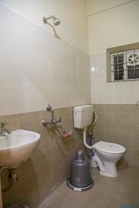 a bathroom with a sink and a toilet at Delightful 3 Bed holiday home with AC Near US Embassy, Gachibowli in Hyderabad