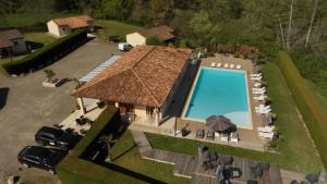 an overhead view of a house with a swimming pool at Hôtel LES LODGES D'EAUZE in Eauze