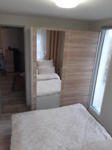 a mirror in a bedroom with a bed in it at Domek POD LASEM in Opole