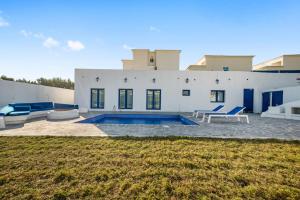 a house with a swimming pool in front of it at Dreams Gate Villa Resthouse 4 in Umm Şalāl ‘Alī