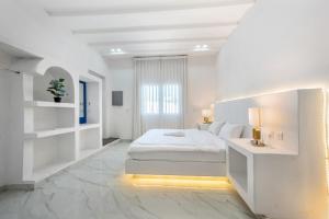 a white bedroom with a bed and a desk at Dreams Gate Villa Resthouse 4 in Umm Şalāl ‘Alī +20 photos