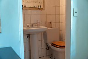 a bathroom with a sink and a toilet at Casa con parque y vista al lago in San Carlos de Bariloche +30 photos