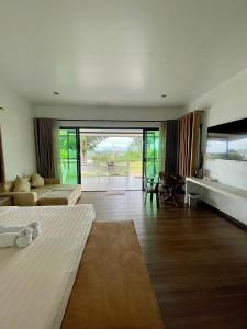 a large room with a bed and a living room at River valley resort แอทน่าน in Nan