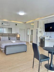 a bedroom with a bed and a table and a kitchen at River valley resort แอทน่าน in Nan +263 photos