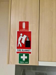 a fire alarm sign on a wooden door at Cool City 1 Bedroom in Melbourne