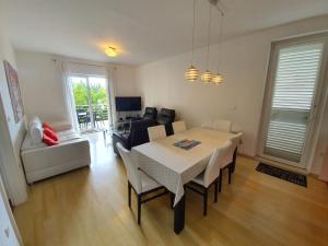 a living room with a table and chairs and a couch at Apartments Laus in Dubrovnik