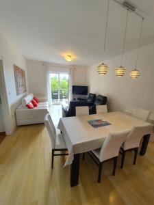 a dining room and living room with a table and chairs at Apartments Laus in Dubrovnik