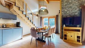 a kitchen and dining room with a table and chairs at Chalet Grand Croix - Haut Standing - 8, 10 pers in Lanslebourg-Mont-Cenis