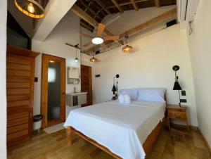 a bedroom with a large white bed in a room at Hydrogen Beach Bar and Resort in San Francisco +95 photos