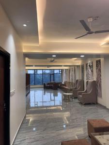 een lobby met banken en stoelen in een gebouw bij Phoenix Wedding & HomeStay in Amritsar