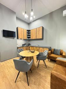 a kitchen and living room with a table and chairs at EVIS LTD apartments 4 in Rēzekne