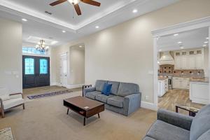 a living room with a couch and a table at Luxurious 4-Bedroom Oasis with Private Pool in Seguin