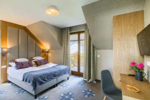 a bedroom with a bed and a large window at Villa Źródło & Spa in Krynica Zdrój +130 photos