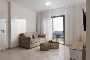 a living room with a couch and a chair at Elita suite - private jacuzzi in Eilat
