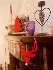 a red reindeer ornament on a wooden table at Family House in Santa Severa +43 photos
