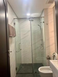 a bathroom with a glass shower with a toilet at HT Home D'el, Dorado 3 in Hanoi