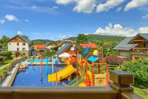 a view of a pool with a water park at Villa Źródło & Spa in Krynica Zdrój