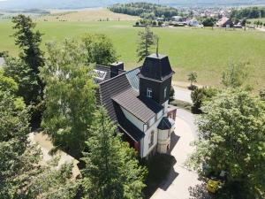 an aerial view of a house with a church at Villa Teufelsmauer in Cattenstedt