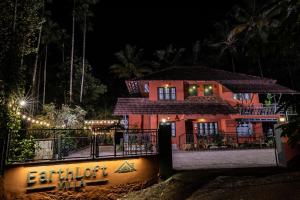 a house is lit up at night at EarthLoft Villa in Kalpetta