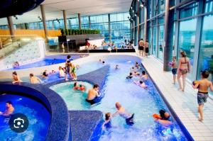 a group of people in a swimming pool in a building at Tjønneveien in Kristiansand
