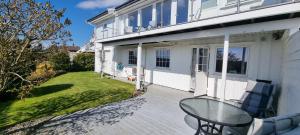 a patio with a table and chairs on a house at Tjønneveien in Kristiansand