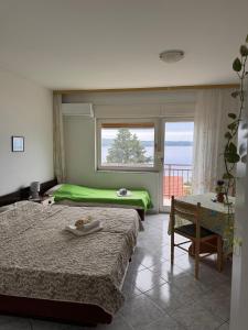 Postel nebo postele na pokoji v ubytování Apartmani Olga