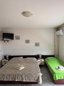 Postel nebo postele na pokoji v ubytování Apartmani Olga + 34 fotografií