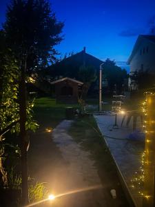 a night view of a driveway with lights at La casa in campagna in Cascina Grossa