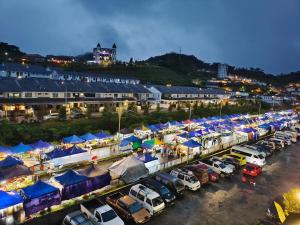 a parking lot filled with lots of cars and blue tents at Cameron Golden Hills Near Night Market CH1 in Brinchang