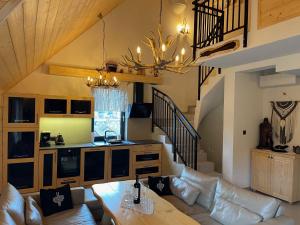a living room with a couch and a table at Apartament Tatry&Pieniny in Szlachtowa