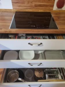 an open drawer in a kitchen withartments at Apartamentos Villa Sofía in San Vicente de la Barquera