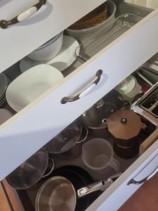 a drawer filled with pots and pans in a kitchen at Apartamentos Villa Sofía in San Vicente de la Barquera