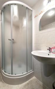 a bathroom with a shower and a sink at Chalupa Evka in Terchová
